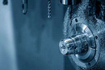 The multi-tasking CNC lathe machine swiss type drilling the brass nipple parts.