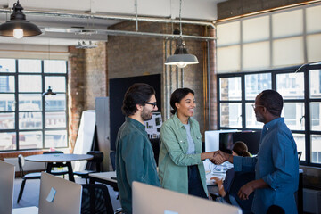 New employee being welcomed to the office with a handshake
