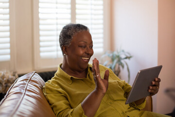 Senior African American woman on a video call on a digital tablet at home