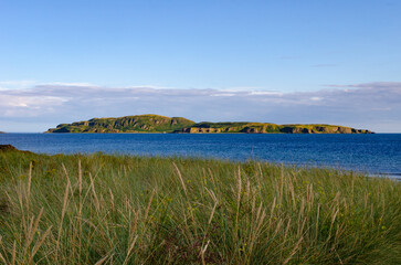 Marram grass at beach in Southend near the Mull of Kintyre Scotland in foreground with Sanda Island in the distance