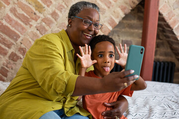 Grandmother and Grandson taking a selfie on a smartphone