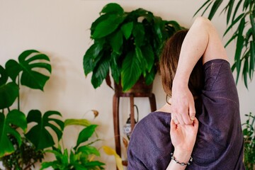 Woman touching her hands behind her back during a yoga exercise