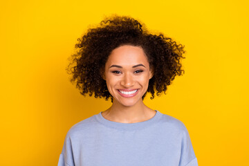 Obraz na płótnie Canvas Photo of sweet adorable curly girl dressed blue pullover smiling isolated yellow color background