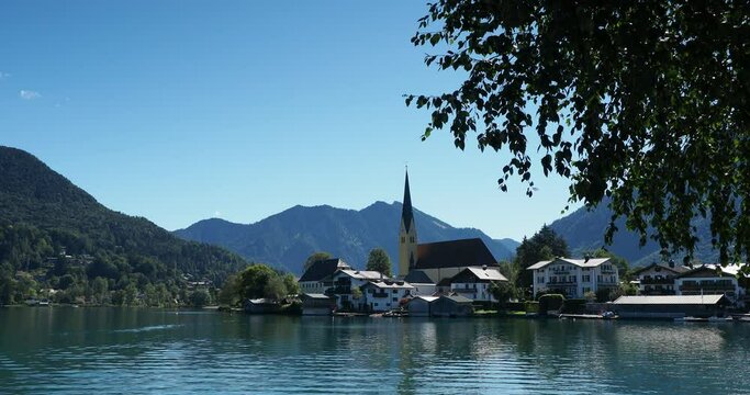 View of Rottach-Egern and Laurentius church on the shore of Tegernsee lake Tegernsee in Bavarian Alps in Germany