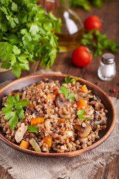 Buckwheat grain porridge with carrot, mushrooms and onion. Lenten vegetarian dish.