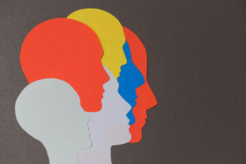 Colored silhouettes of paper cut face. conceptual design for team, slide, cards, banner, Split personality and your creativity.