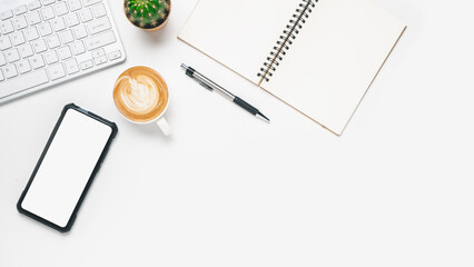 Top view, White Office desk with keyboard computer, Blank screen smart phone, cup of coffee, pen and notebook, copy space, Mock up....