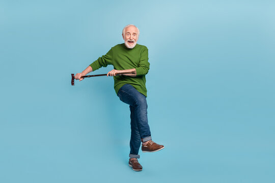 Full body photo of positive aged person hold stick dancing enjoy pastime isolated on blue color background