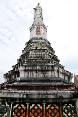 Fototapeta premium The Old Big Pagoda in a Thai temple is one of famous tourist attractions in Thailand with Blue Sky and White Clouds background.
