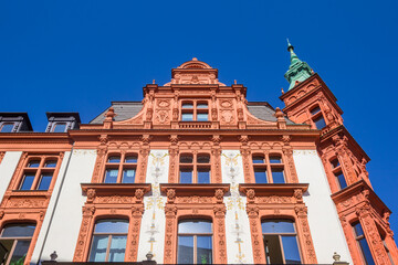 Facade of a historic red building in Leipzig, Germany