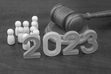 Court and laws in year 2023. Judge gavel, people figures and numbers 2023. 