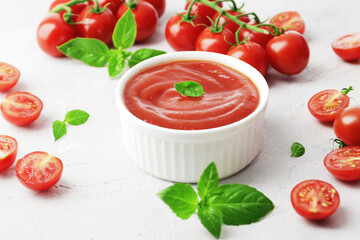Tomato sauce in a bowl, Fresh basil and fresh cherry tomatoes. Ingredients for the sauce. Ingredients for cooking.