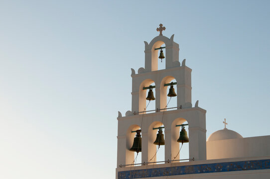 Close-up of a bell tower on the island of Santorini in Greece at sunset