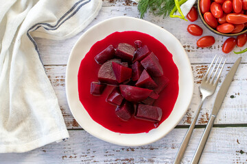 Pickled Red Beetroot. Pickled beetroot on wood background. Top view
