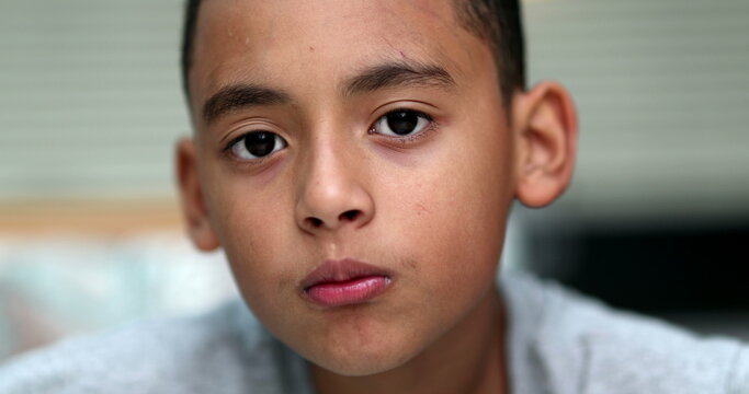 Hispanic little boy child portrait, no expression serious emotion