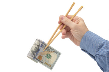 hand holds dollars with bamboo chopsticks on a white background. financial industry in food. cash spending concept