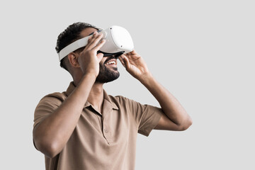 Young man using virtual reality headset isolated on gray background, VR, future gadgets,...