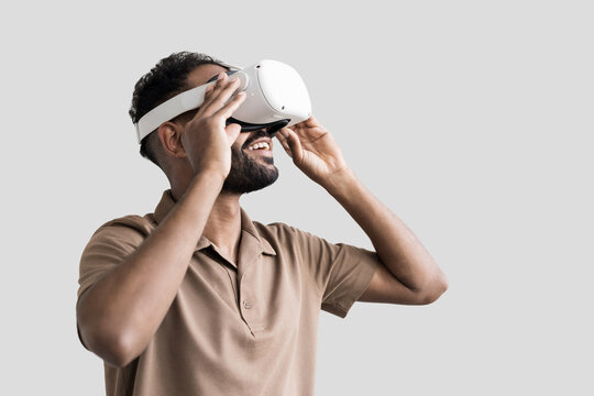 Young man using virtual reality headset isolated on gray background, VR, future gadgets, technology, virtual event, education, study, learning, video game concept