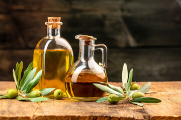 green olives with olive oil. extra virgin olive oil jars on a wooden background. place for text