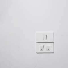 electric light switch and on white wall