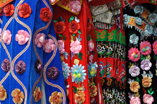 abstract closeup of colorful chinese embroidery on dress and scarf