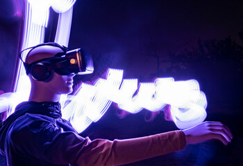 Robot wearing virtual reality simulator standing by light trail