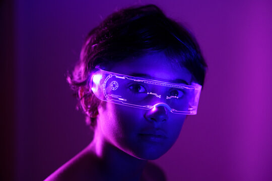 Girl wearing futuristic glasses against purple background