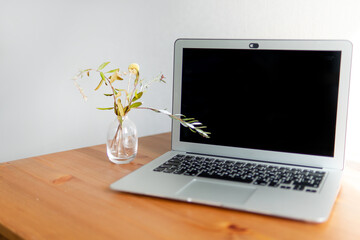 laptop on a wooden table.