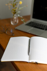 business background. laptop and notebooks are white and grey. notebook in a cage on a beautiful...