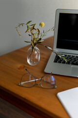 business background. glasses laptop and notebooks white and gray. notebook in a cage on a beautiful...
