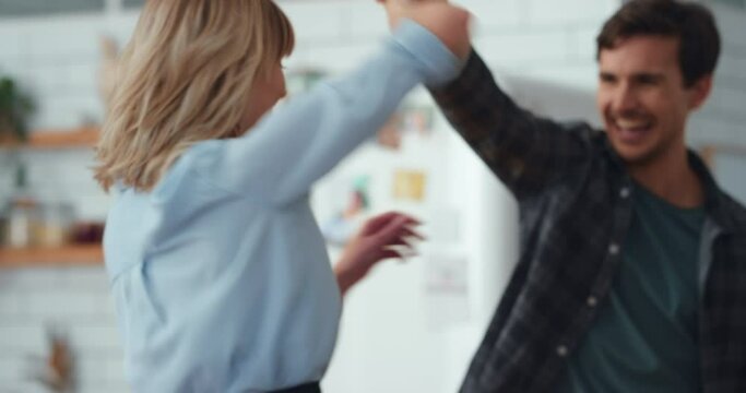Dancing, energy and love of happy couple having fun in celebration of their anniversary at home while laughing and feeling joy. Happy married man and woman being active and enjoying romantic moment