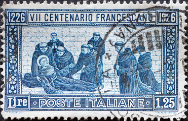 ITALY - CIRCA 1926: a postage stamp from ITALY , showing a group of monks at the deathbed of St....