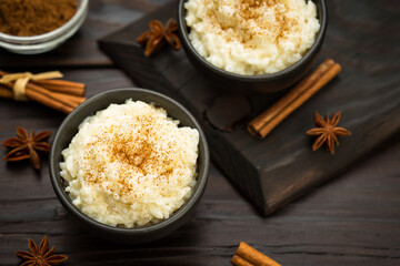 Rice pudding with cinnamon on  the wooden background