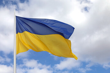 ukrainian flag on blue sky with blue and yellows colors