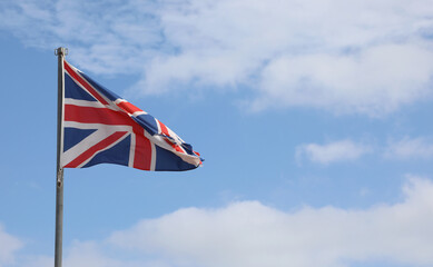 united kingdom flag on the blue sky and white clouds