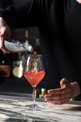 putting ice in cocktail