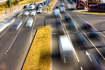 The movement of vehicles on the highway in the daytime. View from the bridge.