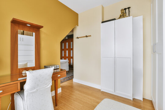 Interior of workroom with wardrobe and office table