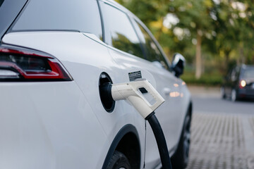 Fototapeta premium electric car charging in the station 