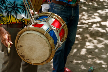 Dominican Republic. The musician plays the drum. Drummer. A group of beach musicians. Merengue music.