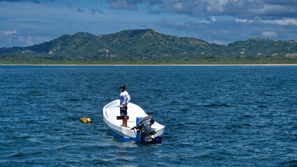 Small boat moored off the beach in Tamarindo, Costa Rica