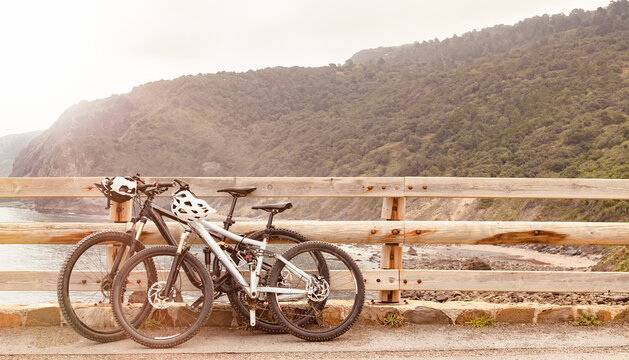 Electric mountain bikes on the wooden fence, coastal ride