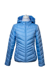 Winter jackets. Close-up of a stylish cosy warm blue down jacket for womans on mannequin isolated on a white. Fashionable women clothes for spring and autumn.