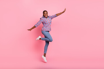 Full body photo of energetic cheerful lady jumping enjoy good mood isolated on pink color background