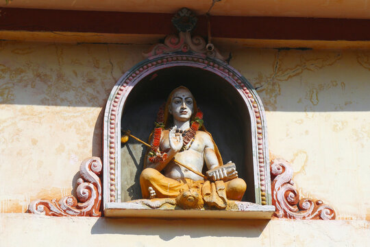 Ramanuja is a Hindu sage in lotus position with a blessing gesture. Religious statue on the temple roof in Gokarna.