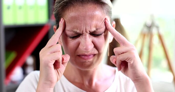 Frustrated young woman coping with headache and migraine concept