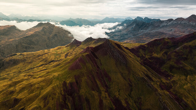 Aerial photograph taken from a drone over the top of the Castillo de Acher peak in the Western valleys next to the Selva de Oza, Hecho. Aragon. Spain, in it you can see the forest and the storm clouds