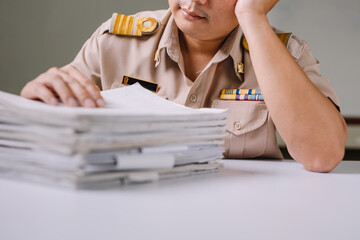 Thai government teachers are stressed with paperwork for assessment with a tired look, the concept of education problems in Thailand is full of paperwork and assessment.