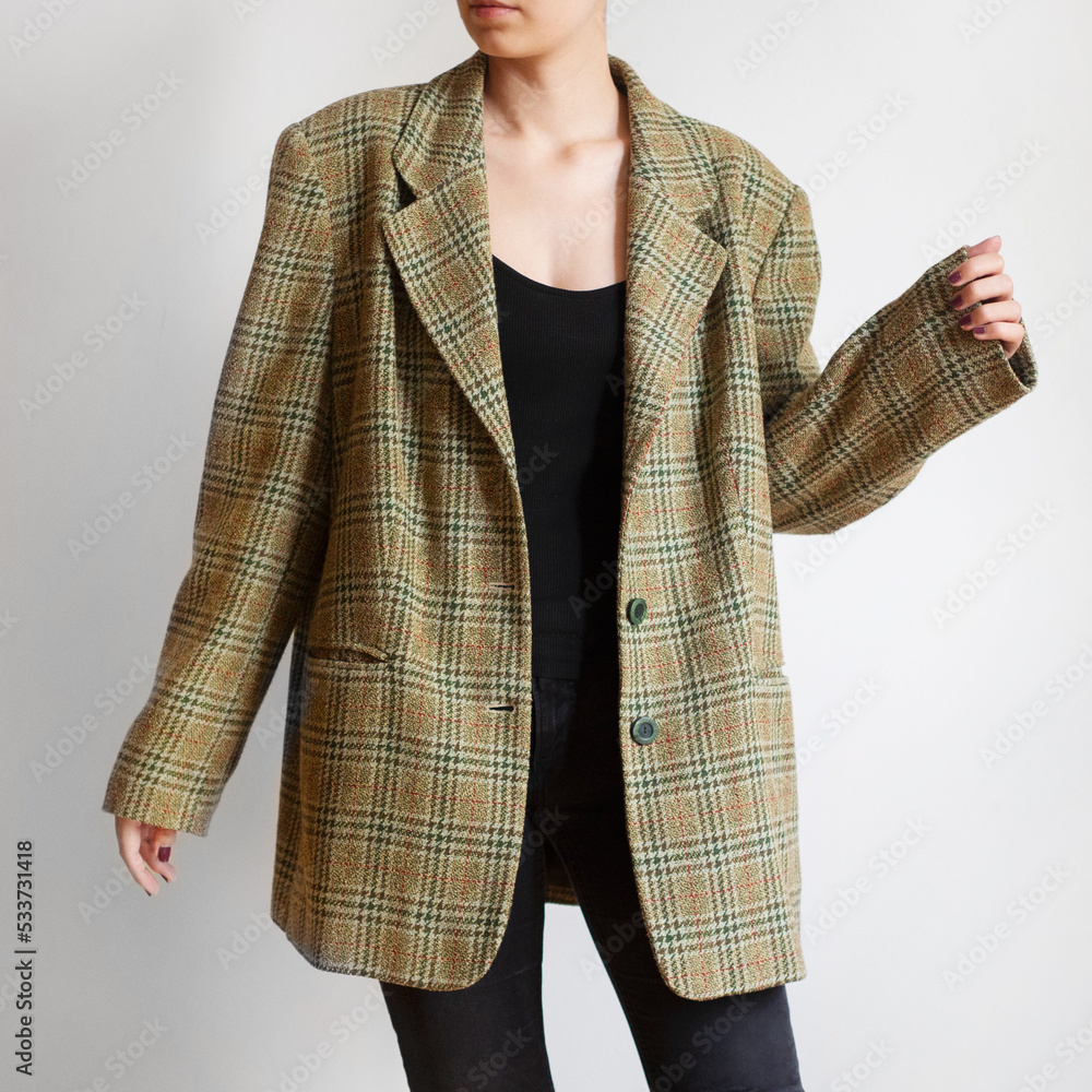 Poster Woman wearing oversized check blazer and black jeans isolated on white background