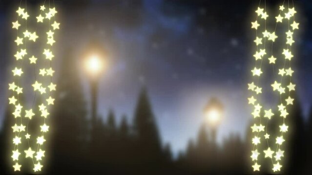 Animation of glowinmg star christmas string lights swaying over nighttime winter scene
